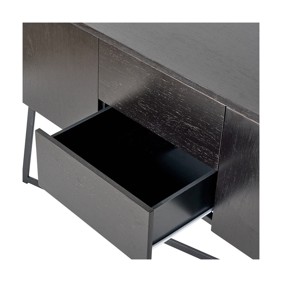 Close-up of the Ukiah black ash veneer sideboard's open drawer, showing black interior lining, black metal legs, and dark wood-grain finish on a plain white background.