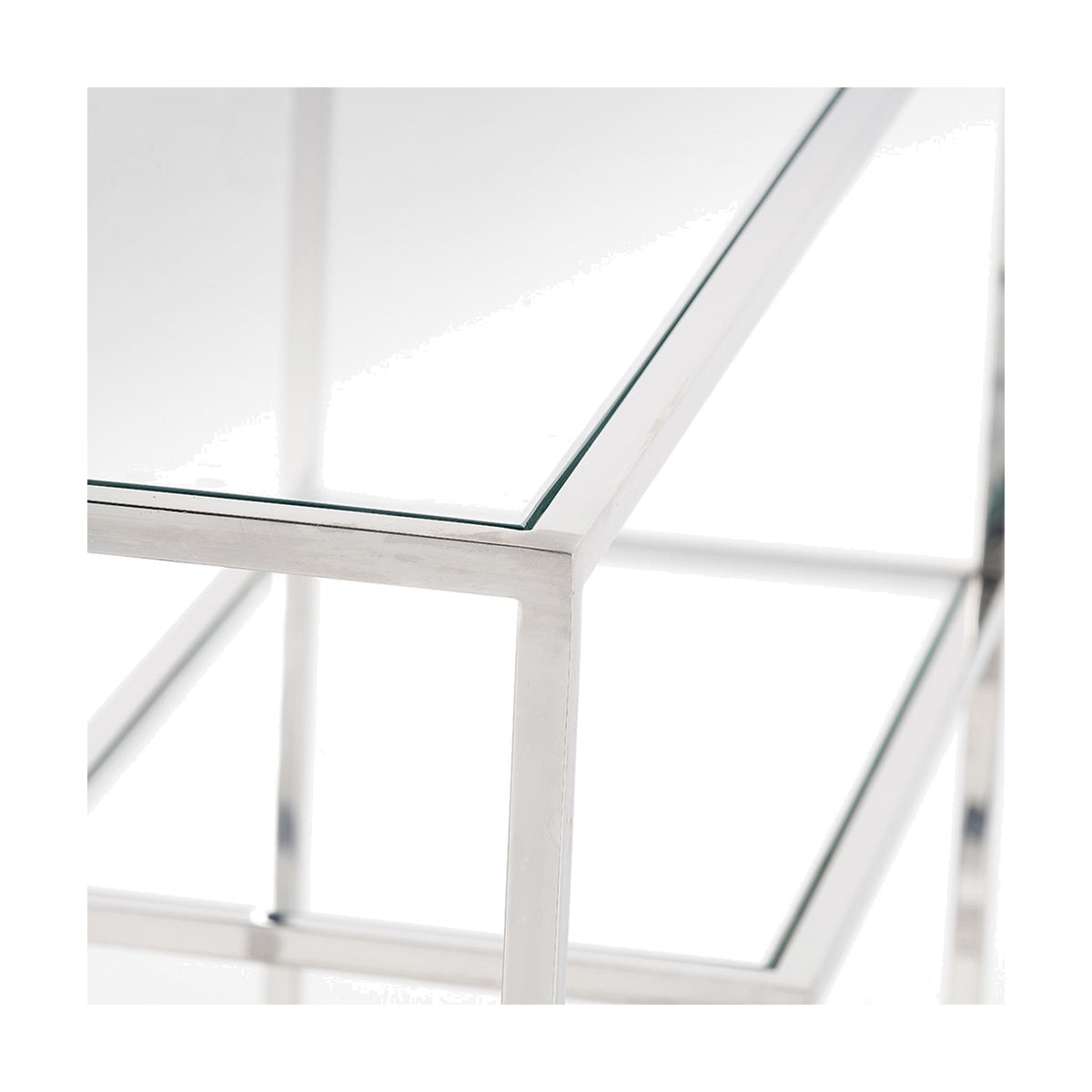 Close-up of the Aleandra Console Table's clear glass top and silver metal frame, showing chrome corner joint detail against a plain white background.