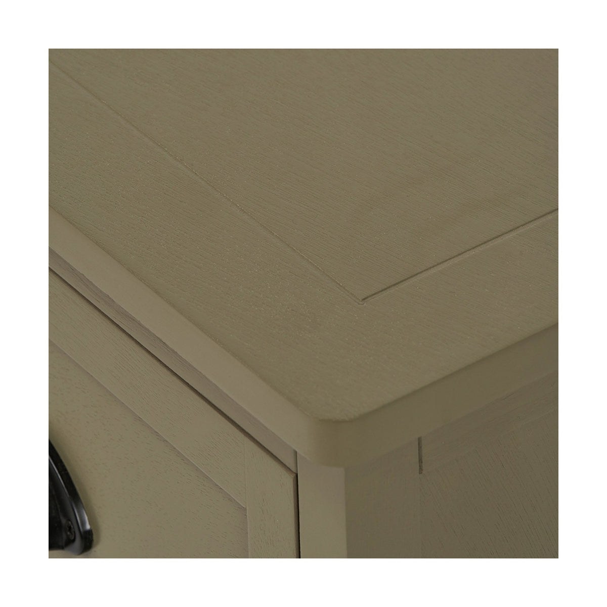 Close-up of the Croft Olive Pine 3 Drawer Unit's top corner, showing wood grain texture, framed panel detailing, and a rounded edge in a muted olive-green finish.