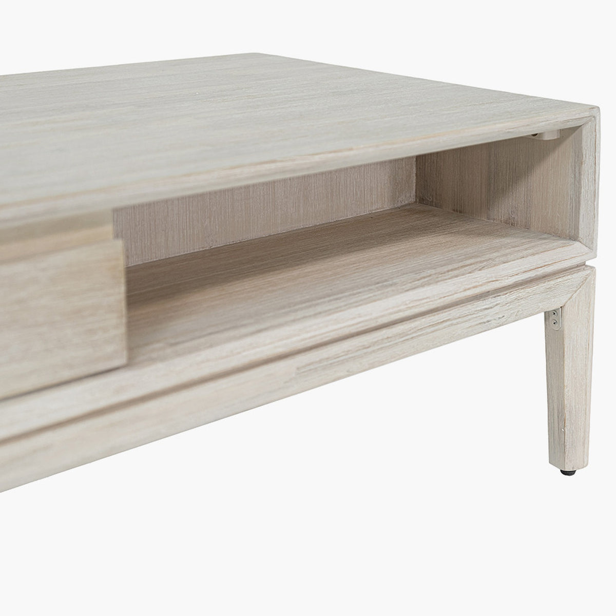 Close-up of the Gio White Sand Acacia 2 Drawer Coffee Table showing the open shelf, wood-grain finish, and tapered leg with foot cap on a white background.