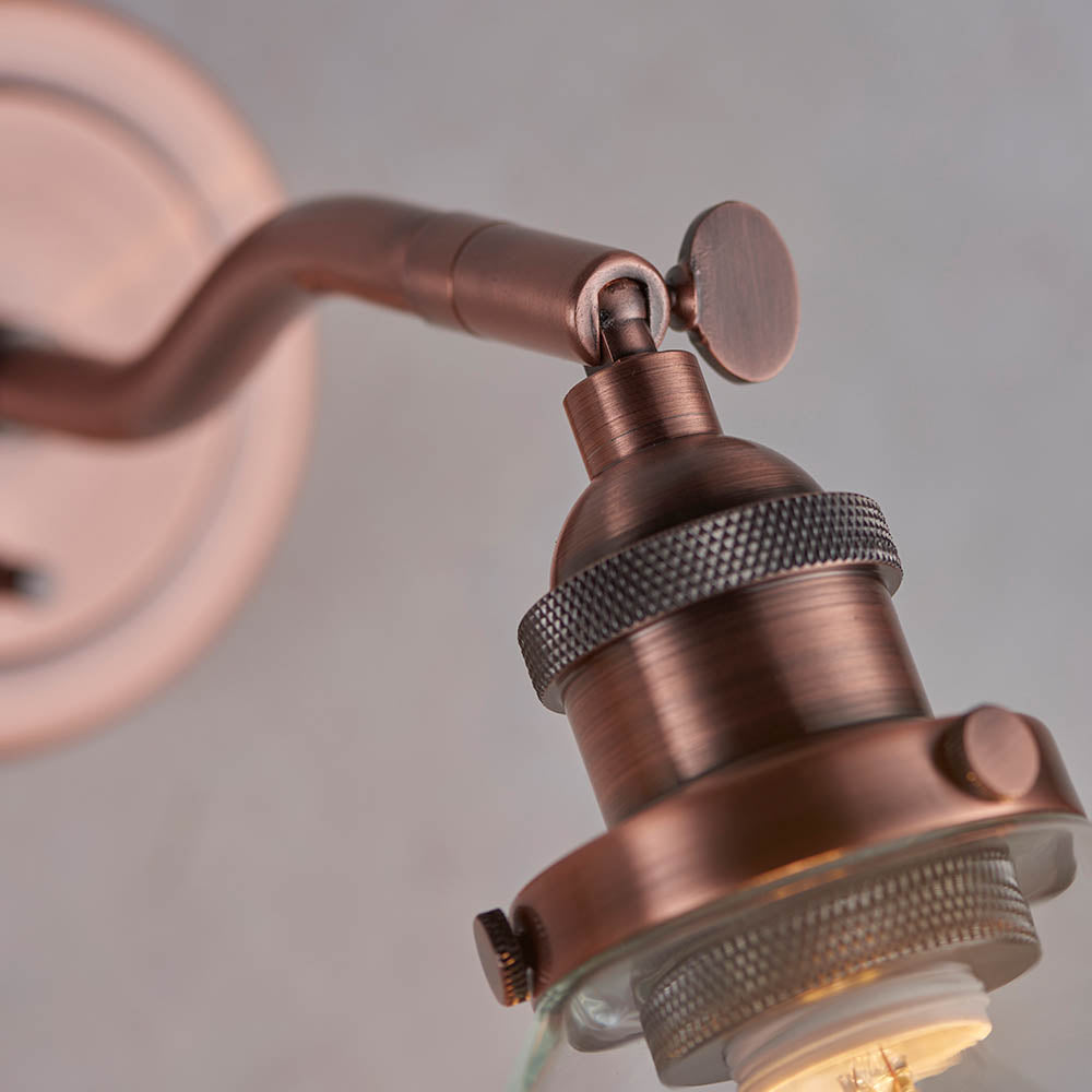Close-up of Endon Wentworth wall light in copper, showing the adjustable knuckle, knurled E14 lamp holder and clear glass shade.