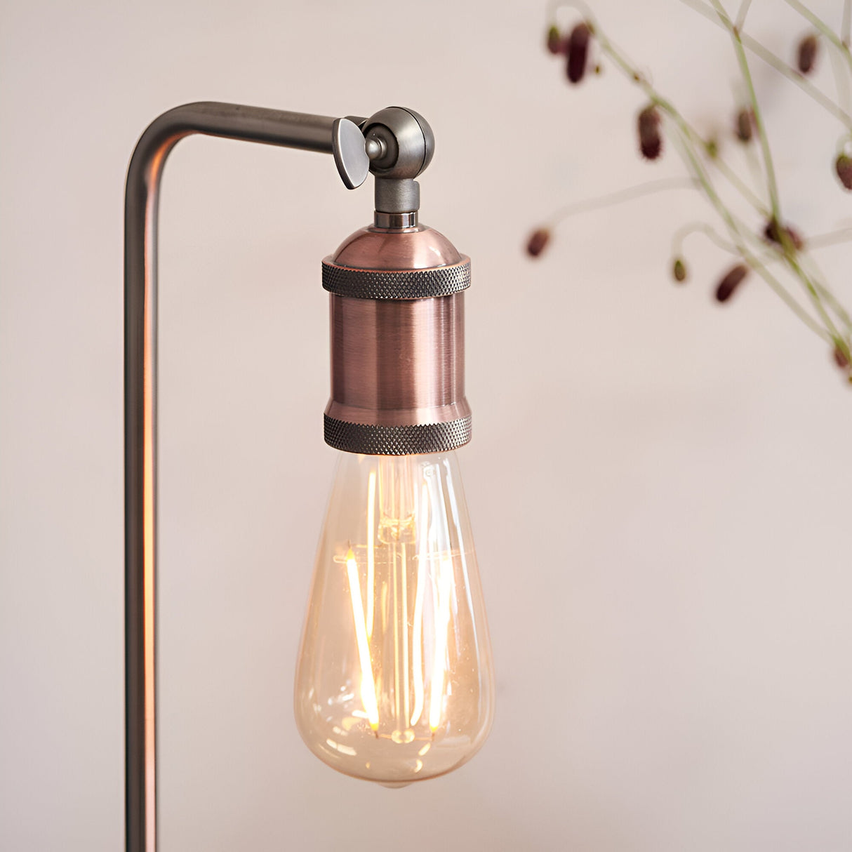 Brackley Table Lamp in copper and silver, close-up of adjustable knuckle joint and knurled E27 lamp holder with exposed bulb, industrial style.