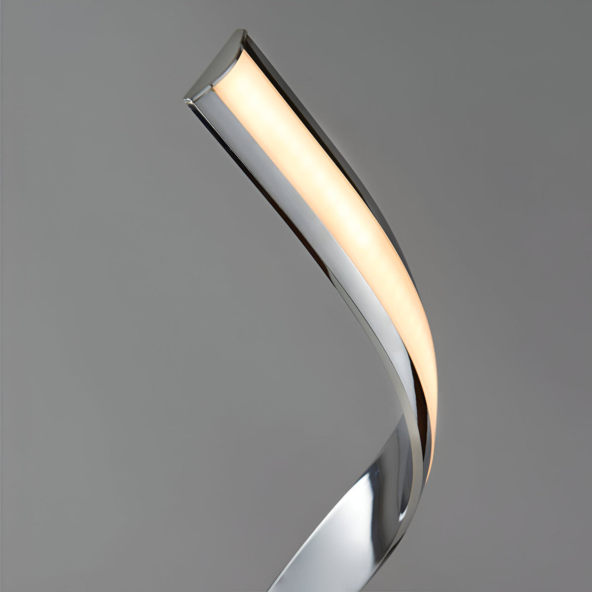 Neve Floor Lamp in polished chrome with a curved, illuminated arm and white diffuser, shown against a plain grey background.