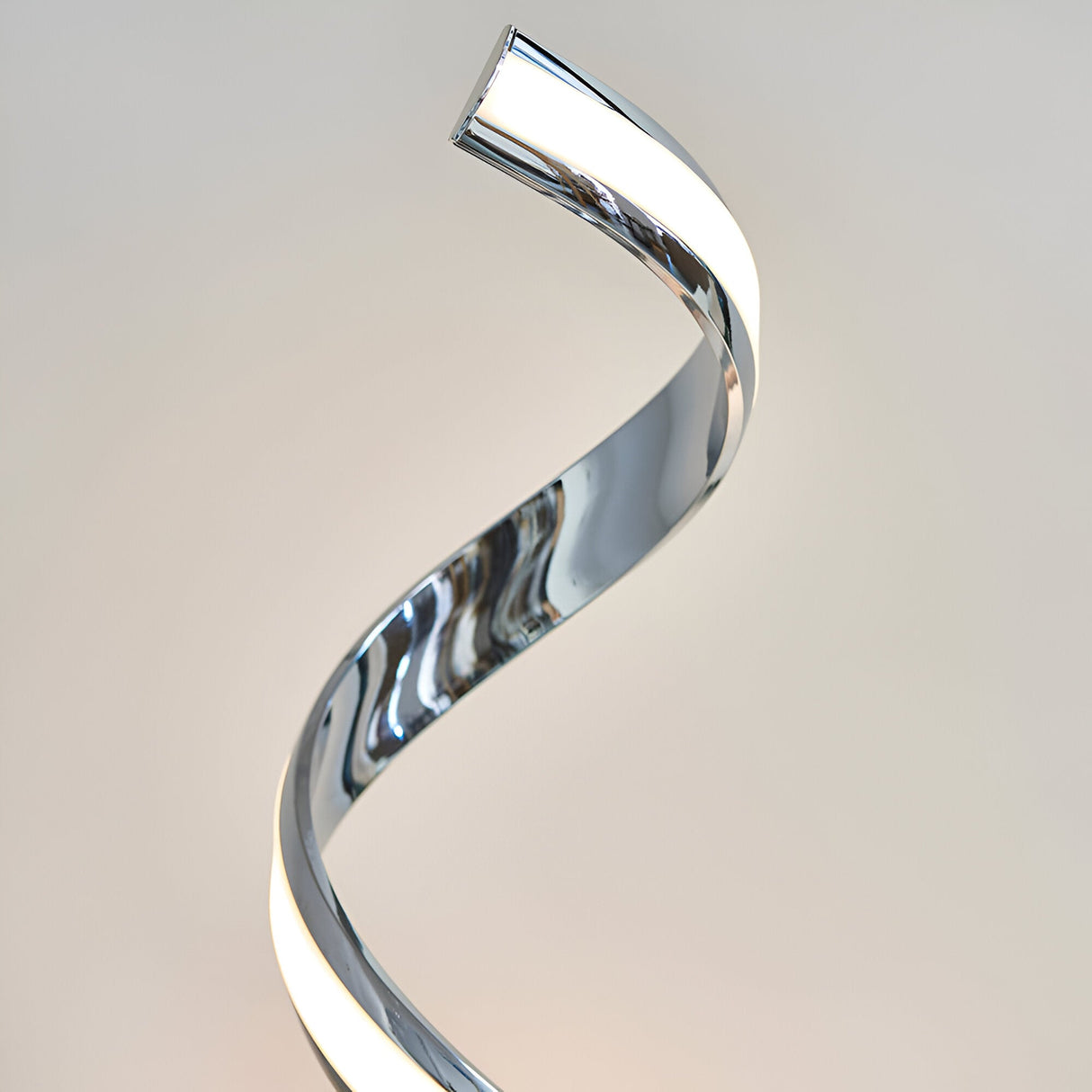 Endon Neve table lamp with a polished chrome spiral form and integrated LED diffuser, shown close-up against a neutral background.