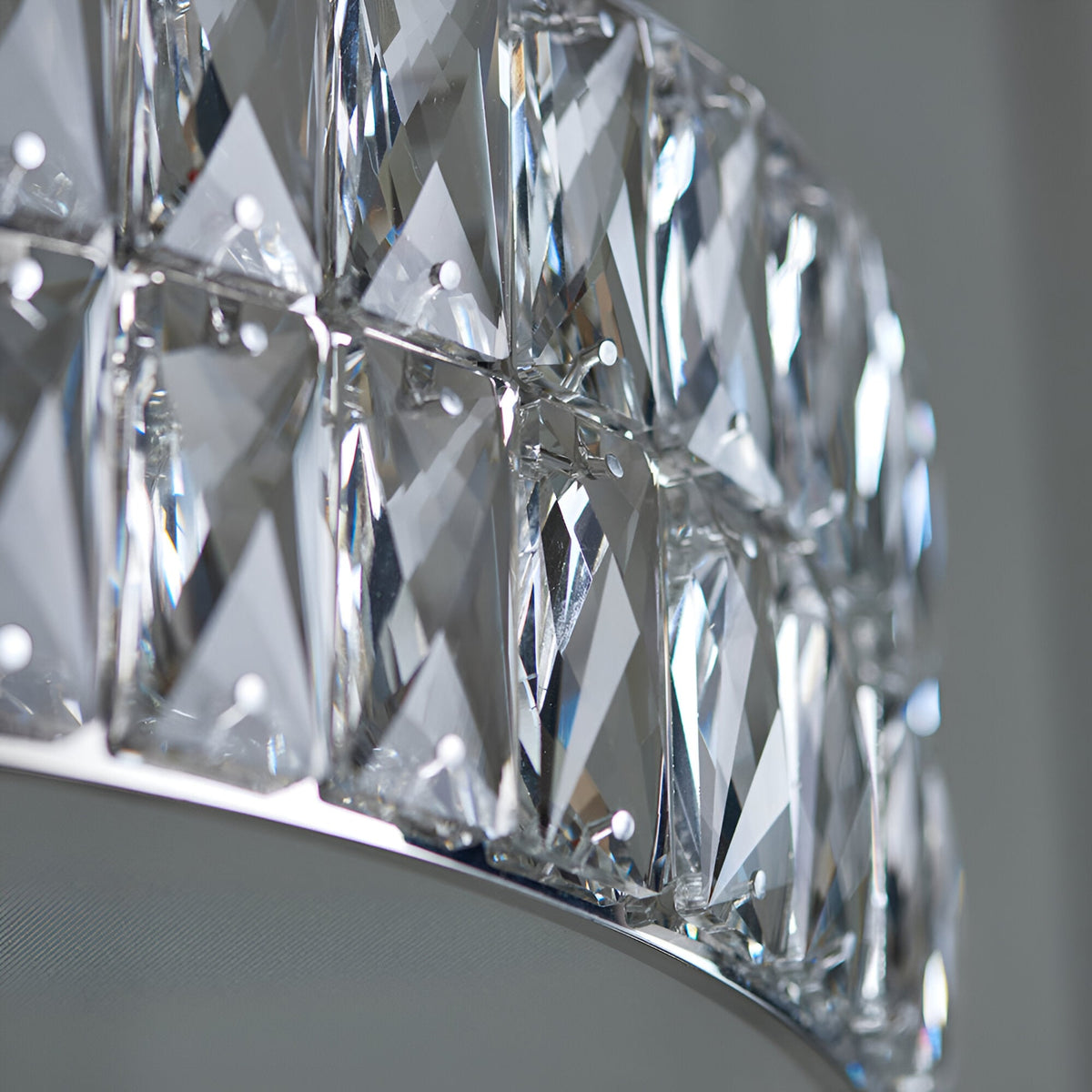 Close-up of the Marguerite LED Round Pendant in chrome, showing faceted crystal panels with polished chrome fittings against a neutral background.