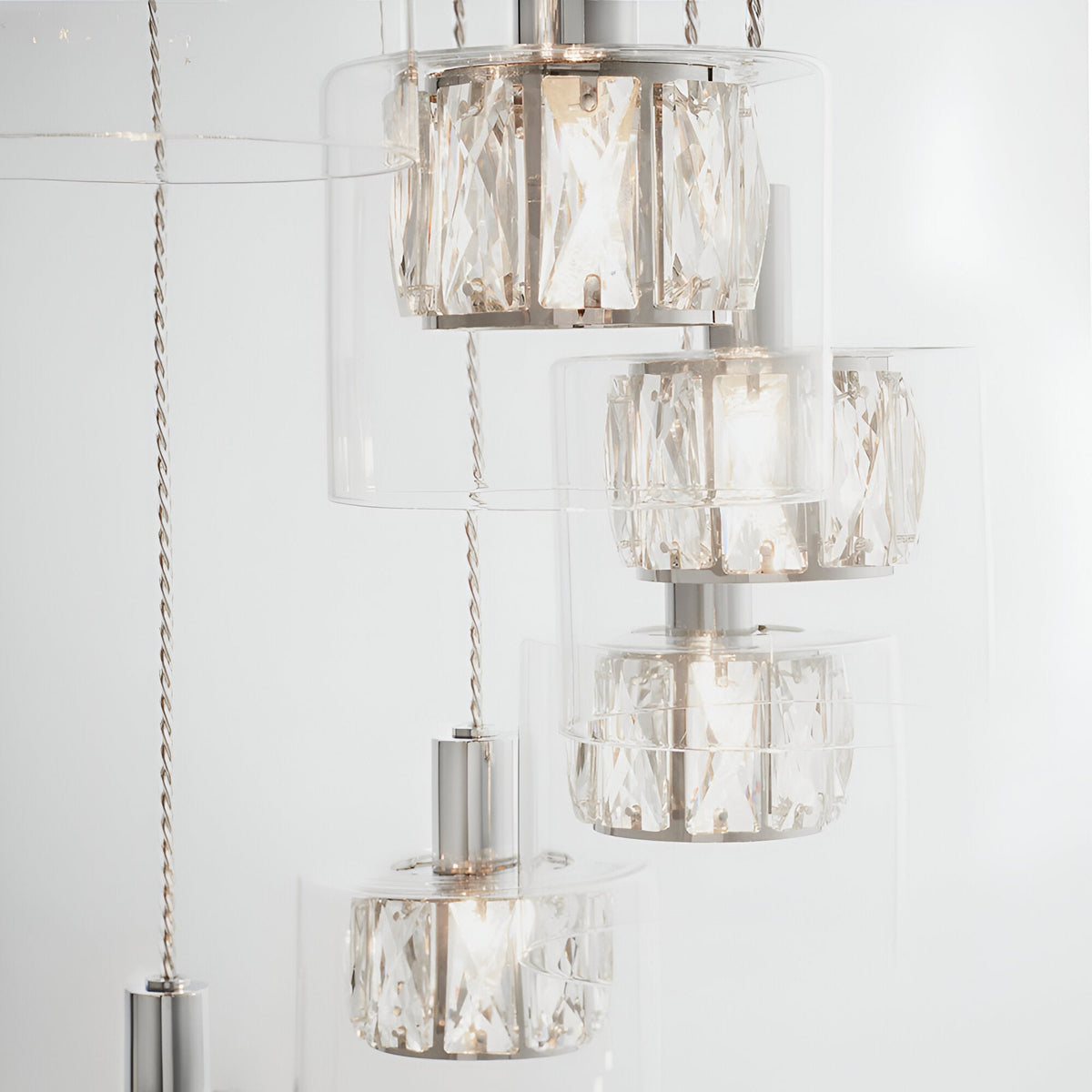 Marguerite 12-light pendant in polished chrome with cascading clear crystal shades at varying heights on adjustable cables.