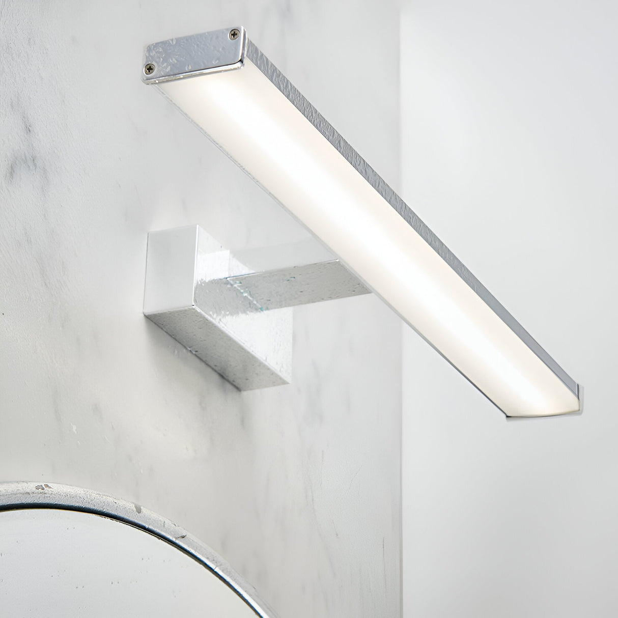 Endon Aldshaw LED bathroom wall light in chrome with a slim frosted diffuser bar on a square bracket, mounted on a marble wall above a mirror.