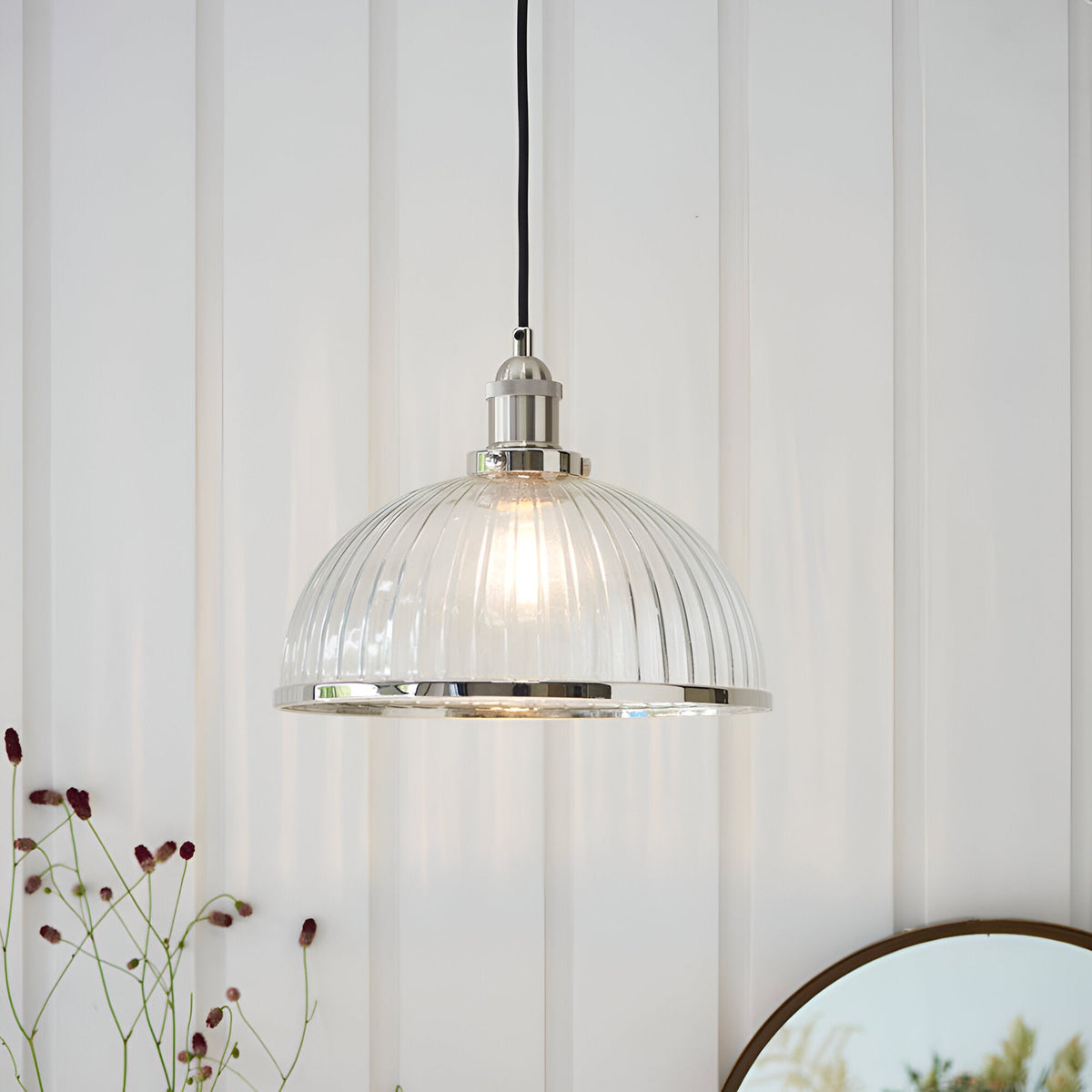 Wentworth Pendant Light in nickel, single-drop fitting with ribbed clear glass dome shade and metal rim, hung on black flex against a panelled white wall.