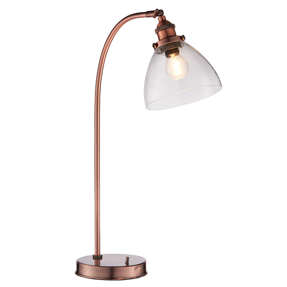 Endon Wentworth table lamp in copper with a curved arm, clear glass dome shade, knurled lamp holder and round base, shown on a white background.