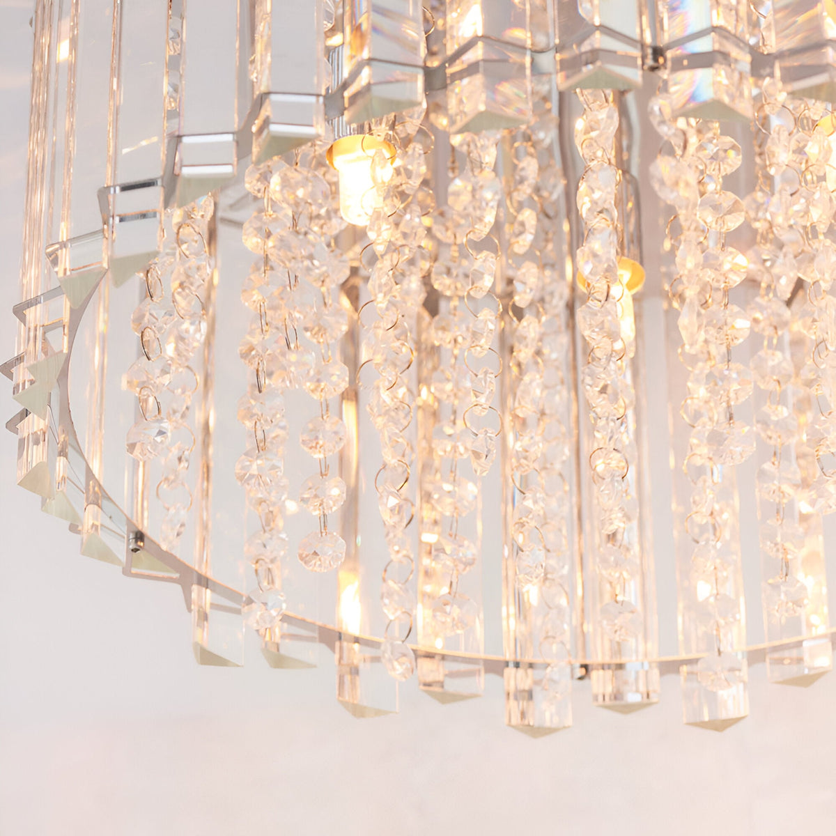 Close-up of the Brenbourne flush ceiling light with tiered clear K5 crystal strands and faceted glass droplets on a polished chrome frame.