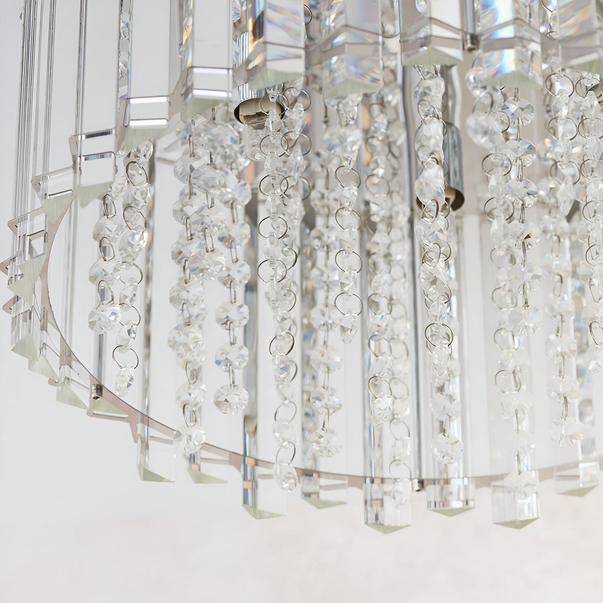 Close-up of the Brenbourne flush ceiling light showing tiered clear crystal droplets on a polished chrome frame, against a plain white background.