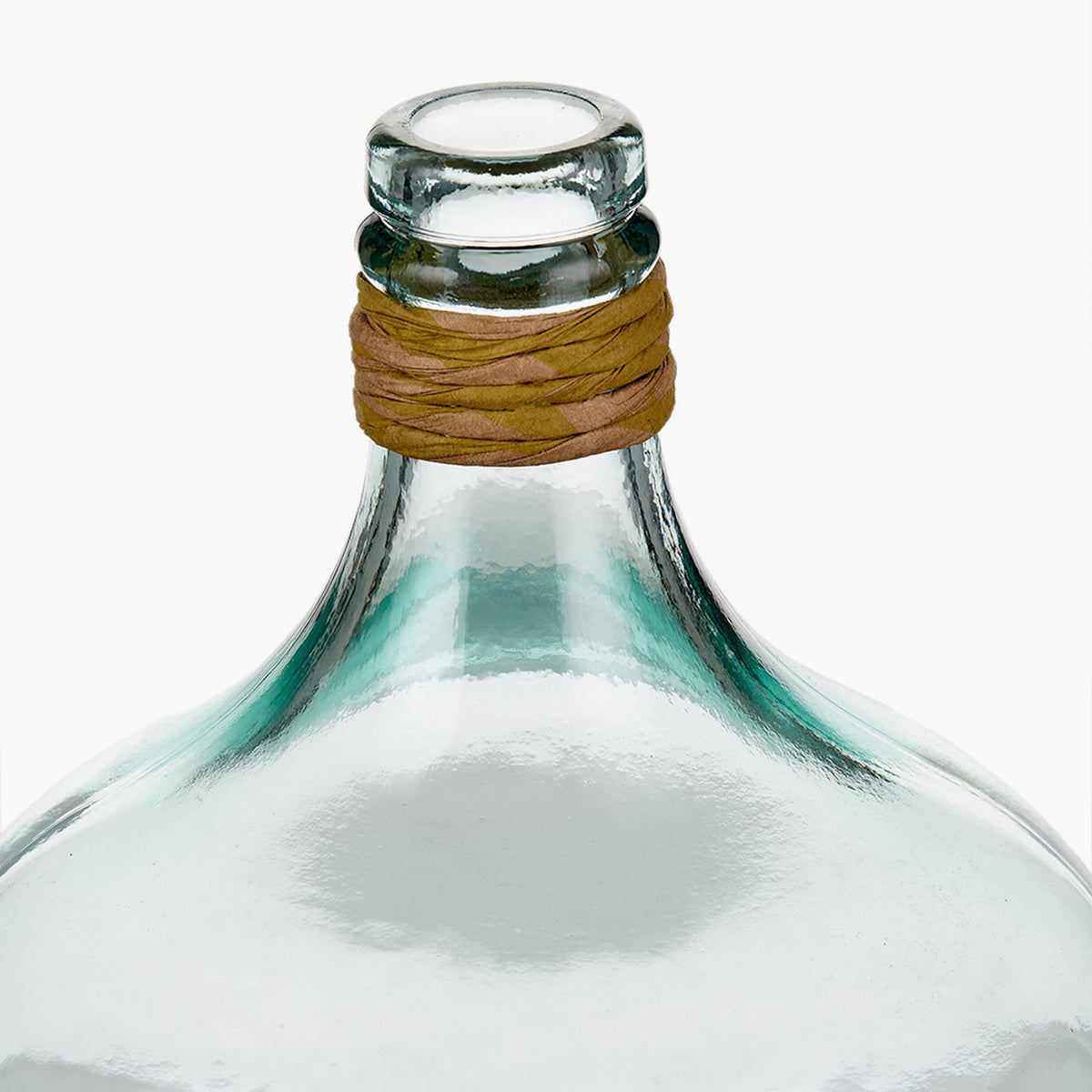 Close-up of a clear recycled glass small bottle vase, 30cm, with a rounded body, narrow neck wrapped in tan raffia, shown against a plain white background.