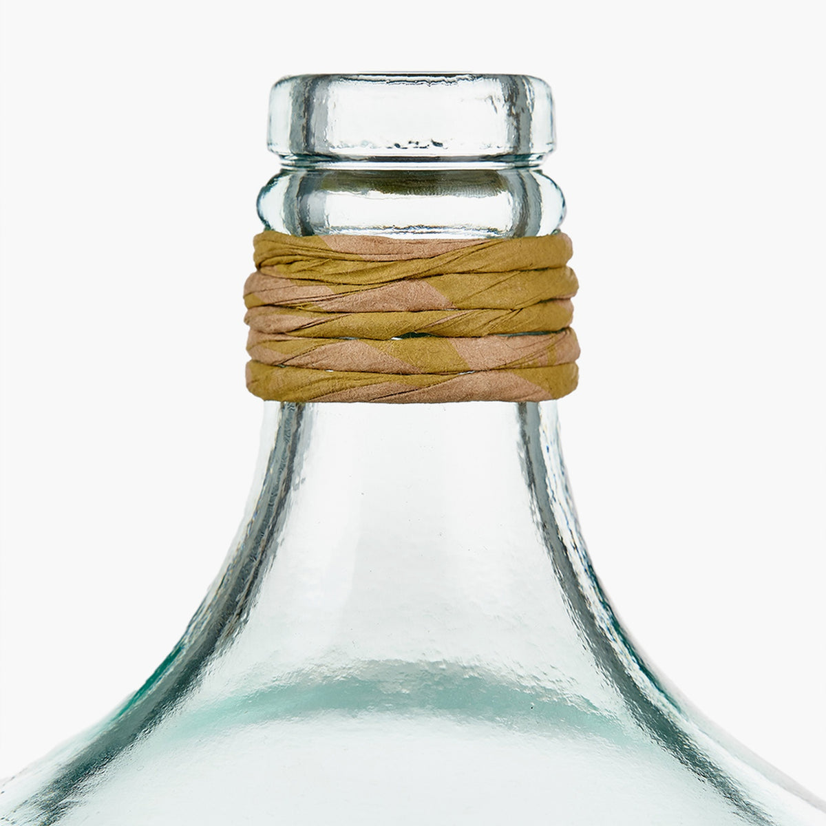 Close-up of a clear recycled glass bottle vase, 30cm, with a tan and gold raffia-wrapped neck, tapered body, on a plain white background.