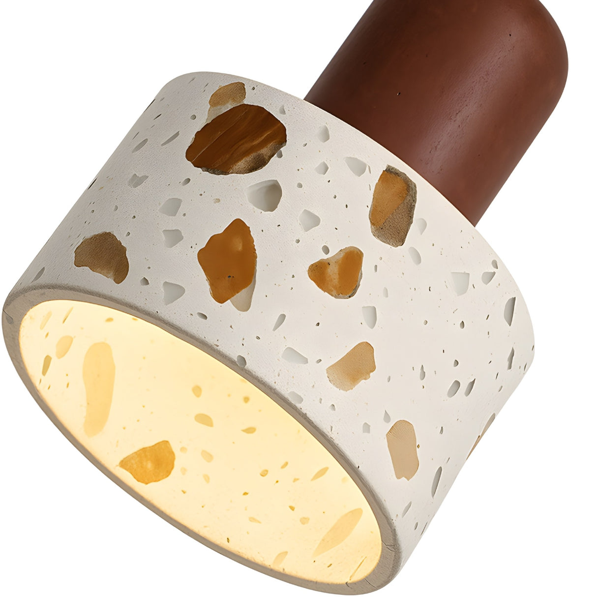 Close-up of the Terroso 1 Light Drum Travertine Single Pendant, featuring a light beige, speckled shade glowing warmly and attached to a smooth walnut brown base.