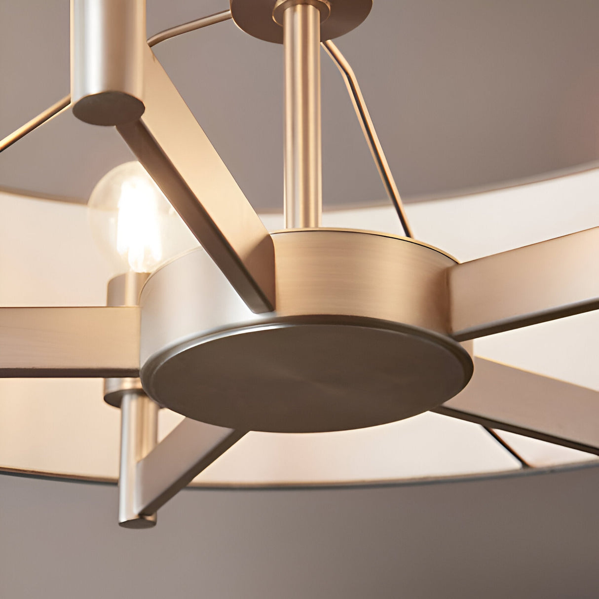 Close-up of Endon Bramstead 5 light pendant showing matt nickel frame arms, central hub, ceiling rod, and grey fabric shade edges with an E27 bulb.