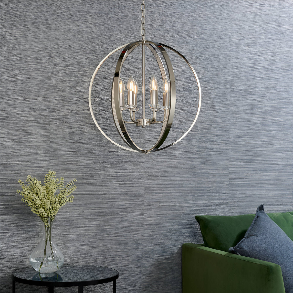 Cliffbury 6 Light Pendant in polished nickel, spherical open frame with candle-style bulbs, hanging above a living room with green sofa and grey wallpaper.