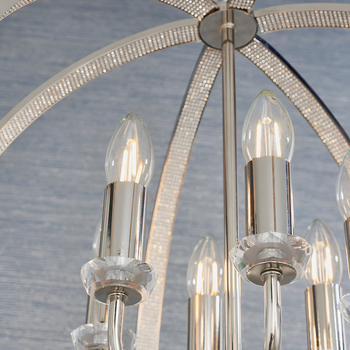 Close-up of the Cliffbury 6 Light Pendant in nickel, showing candle-style bulbs on crystal drip pans beneath faceted, jewel-encrusted arched arms.