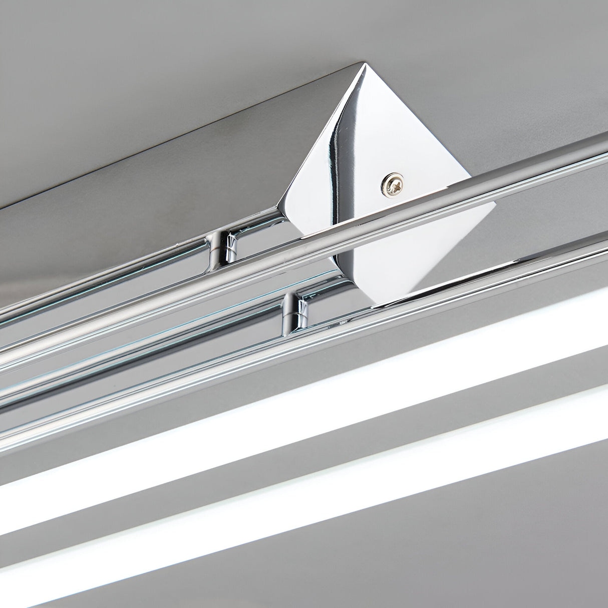 Close-up of the Brencombe 2 Light Linear Ceiling Light in polished chrome, showing the diamond mounting bracket, screw fixing, and dual white diffuser bars.