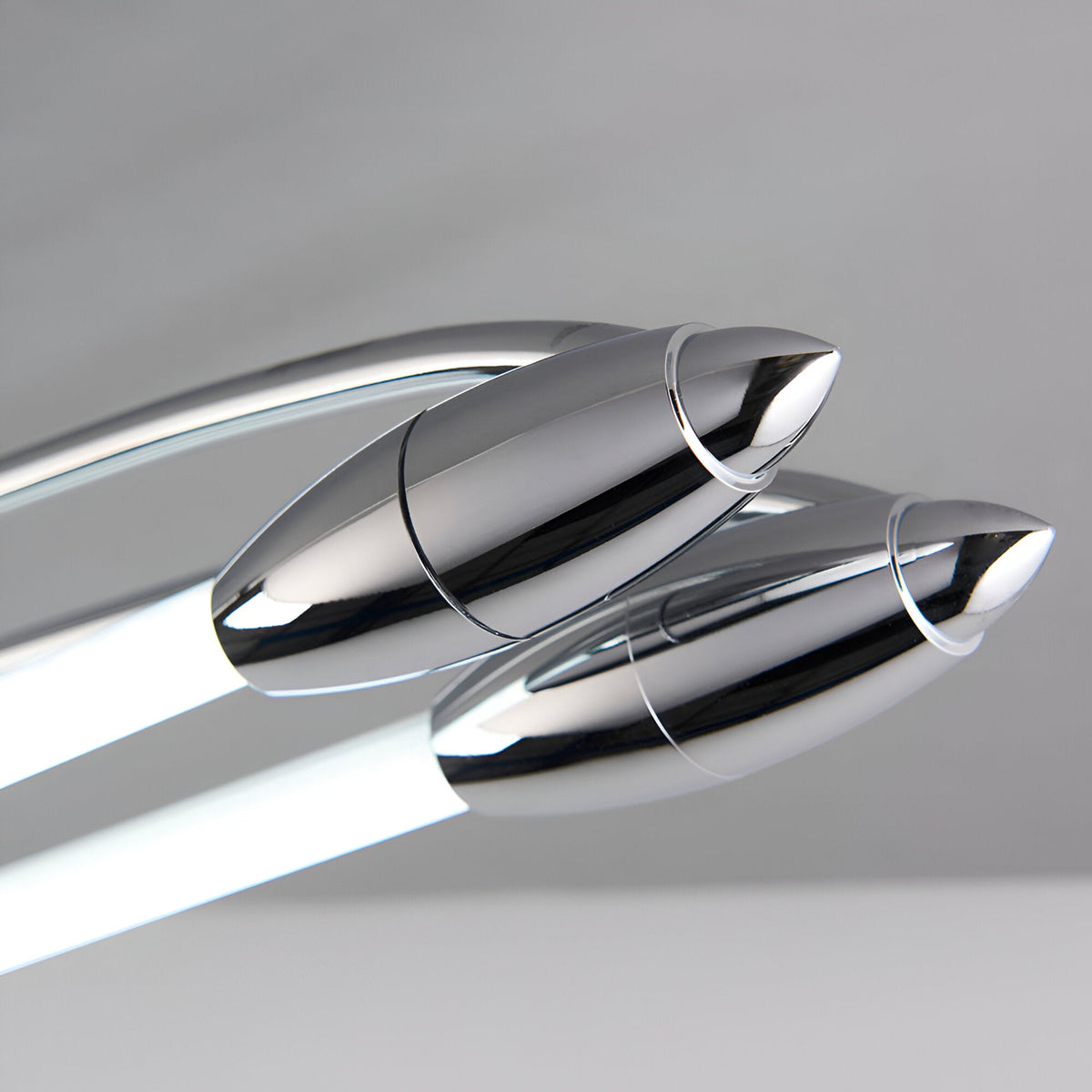 Close-up of the Brencombe 2 Light Small Linear Ceiling Light in polished chrome with bullet-shaped ends and white diffuser bars.