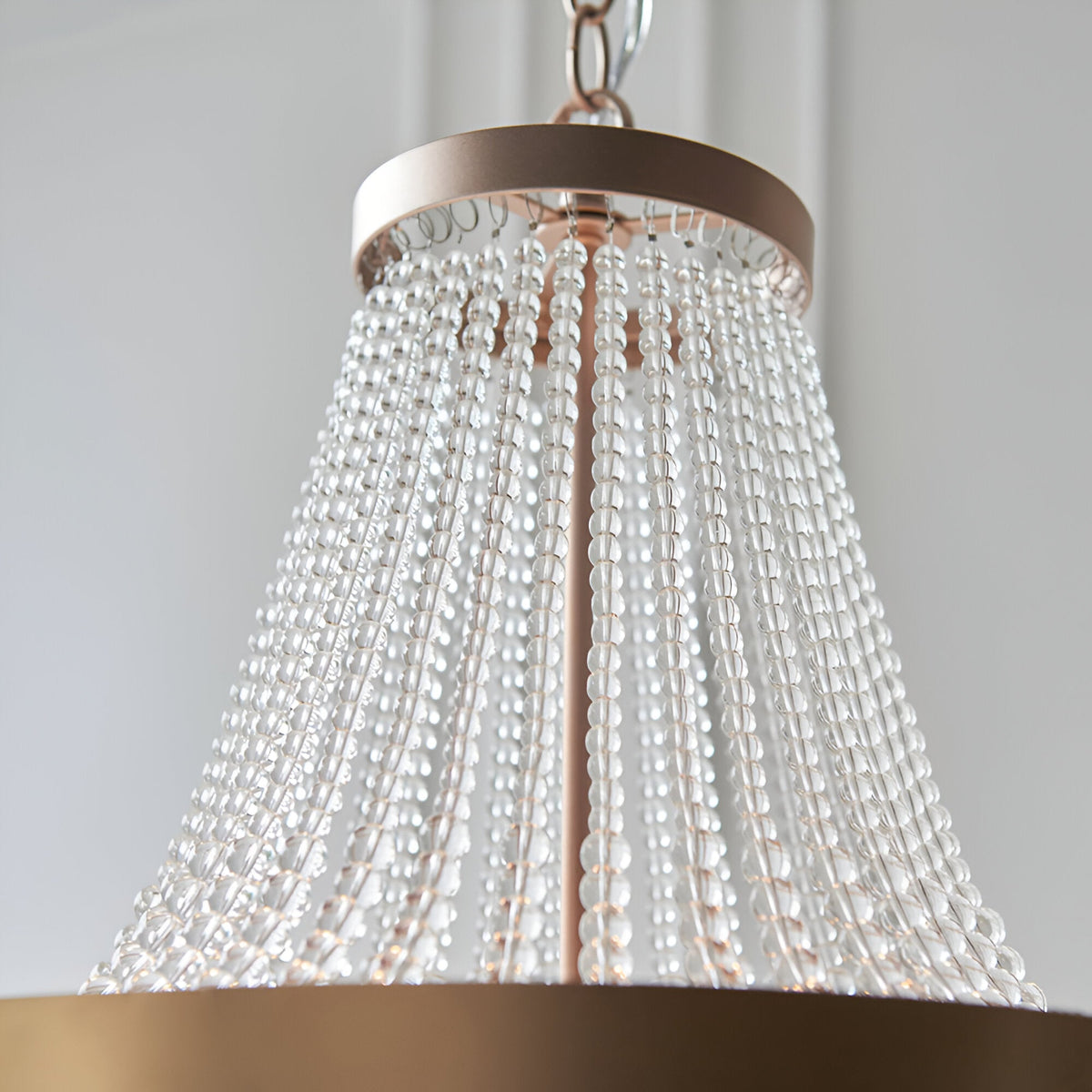 Bevdale 5 Light Pendant in gold, close-up of tiered clear glass beads cascading from a metal ceiling ring, shown against a plain light background.