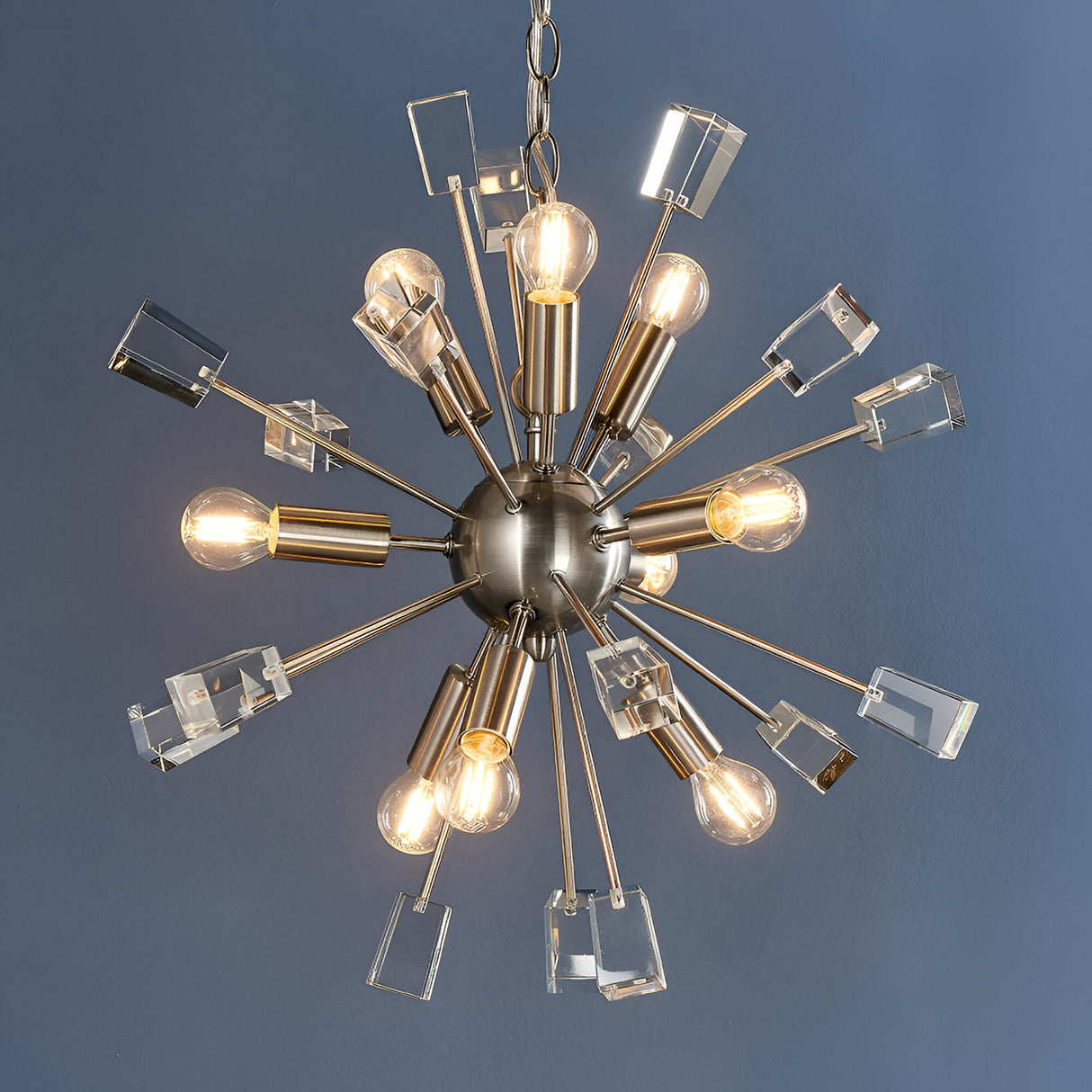 Carlgrove 9-Light Pendant in satin nickel with sputnik-style rods, clear crystal glass accents, and exposed bulbs, shown on a grey background.