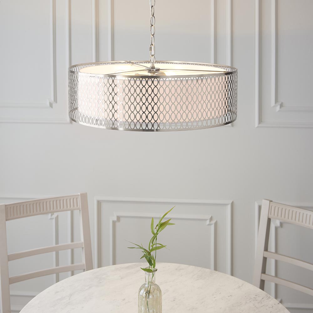 Endon Rosaline 3 Light Pendant in nickel with circular geometric fretwork outer and white fabric inner shade, hung above a marble dining table.