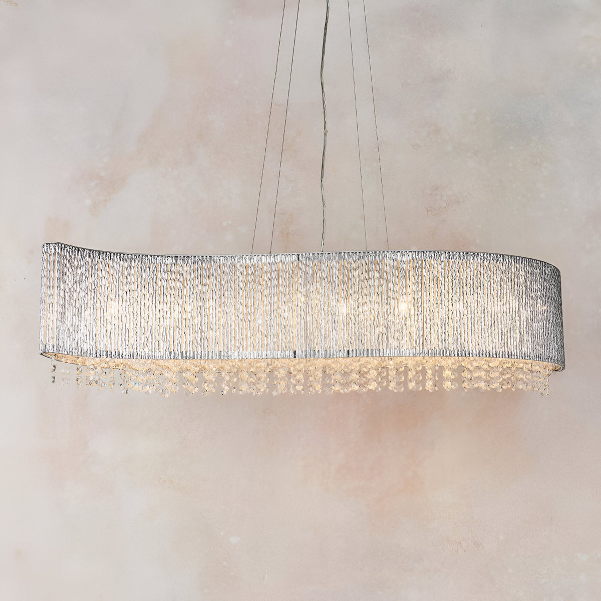 Endon Isadora 8 light linear pendant with a wave-shaped polished chrome frame and clear crystal detailing, suspended against a neutral background.
