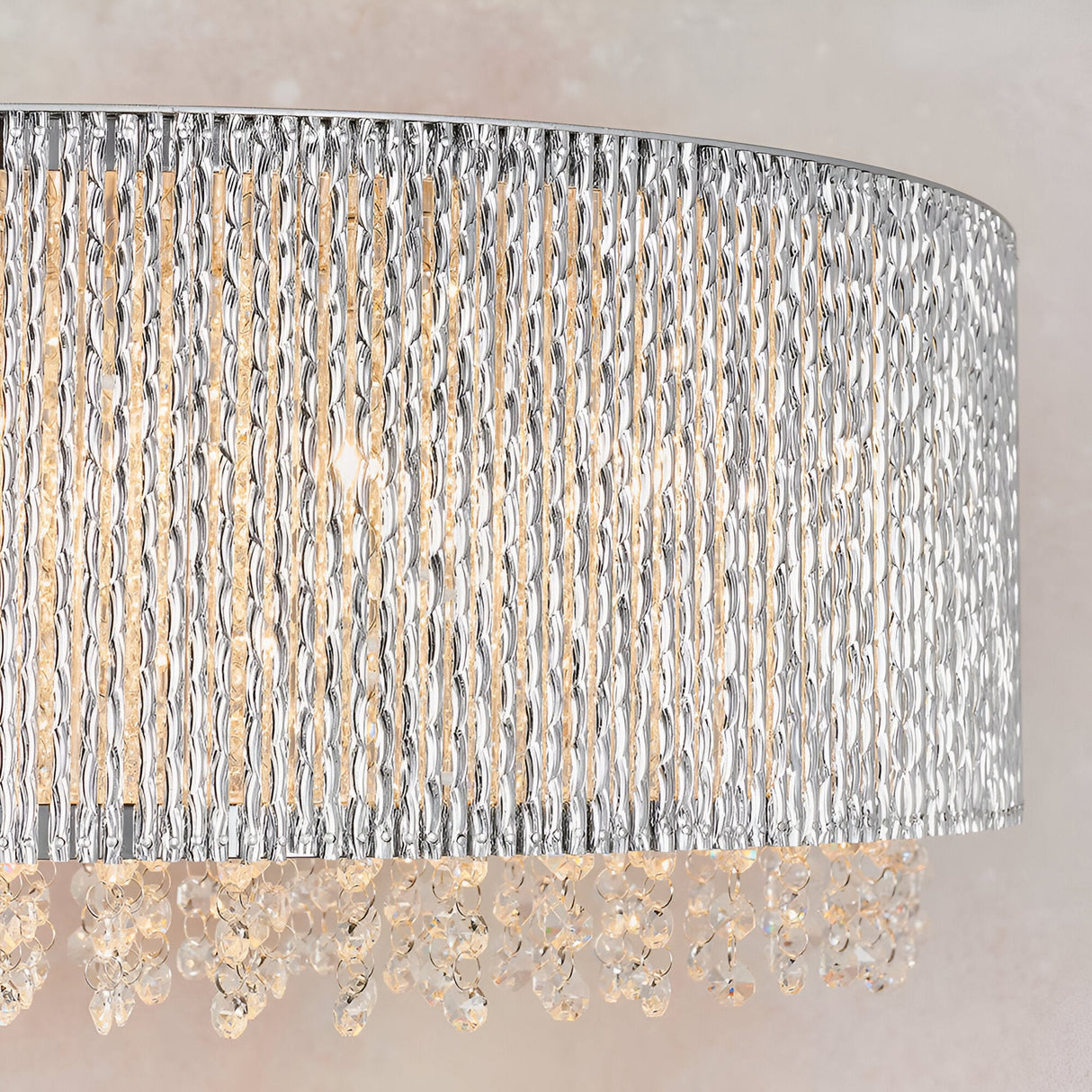 Close-up of the Endon Isadora linear pendant showing twisted polished chrome rods and clear crystal droplets illuminated by warm G9 bulbs.