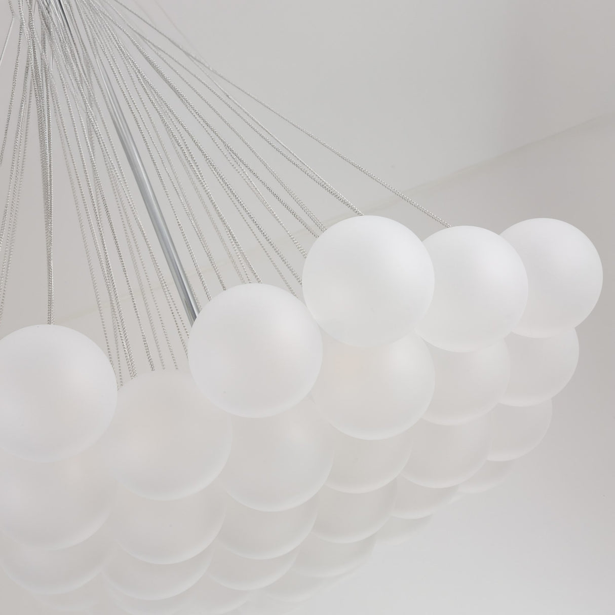 The Orb 37 Light Cluster Suspension - Silver features frosted white spheres suspended by thin wires in a geometric design, offering a modern frosted glass chandelier look ideal for contemporary spaces.