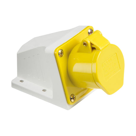 The image displays a 16A 2 Pole Earth Angled Surface Mount Socket in yellow and white, featuring an IP44 protective cap for safety. Four screws are visible securing the setup.