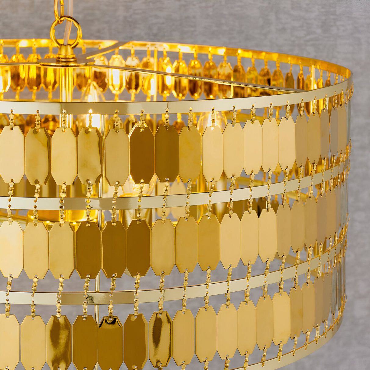 Close-up of the Brackhurst 5 Light Pendant in gold, showing layered rows of small hexagonal gold-plated metal tiles creating a shimmering cascade effect.