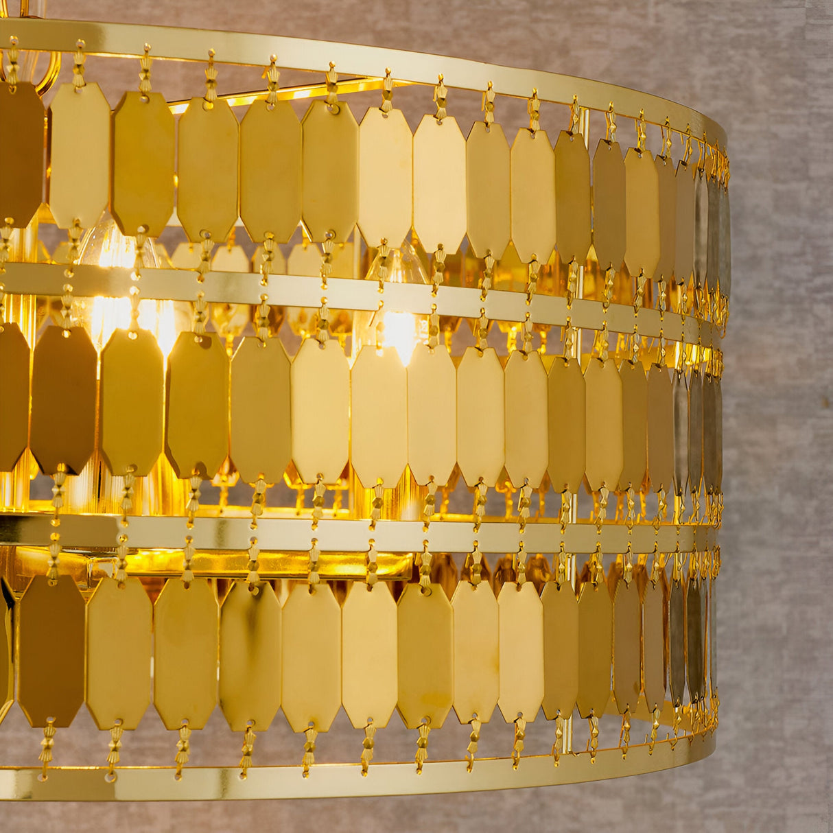 Close-up of the Brackhurst 5 Light Pendant in gold, showing tiered hexagonal metal plates and exposed bulbs against a neutral background.