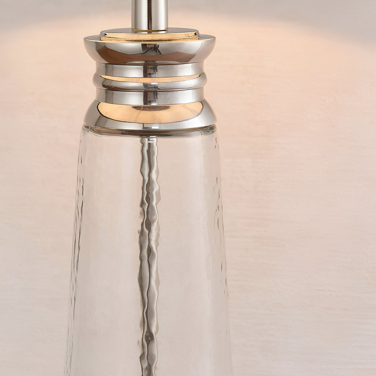 Close-up of the Endon Danehurst table lamp base, showing clear hammered glass with tiered bright nickel plated metalwork.