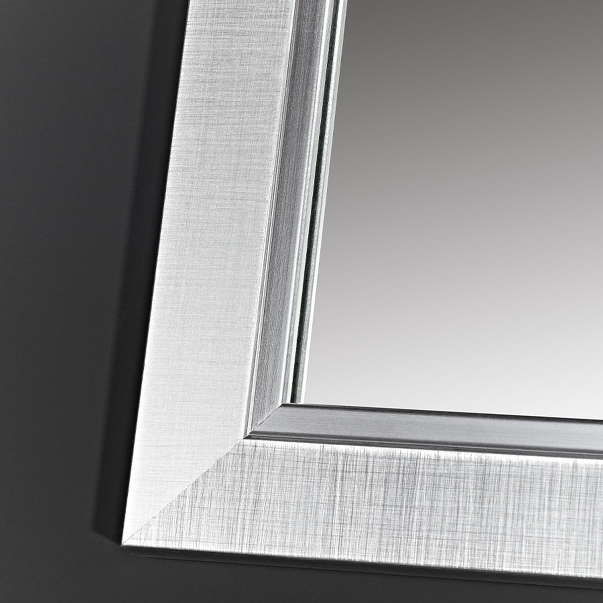 Close-up of the Bremen Silver full length mirror's corner, showing a stepped moulded frame with a brushed silver finish over a darker ground.