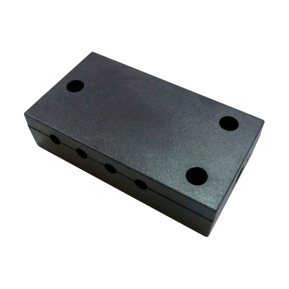 The 12/24V DC 8-Way PVC Splitter, crafted from durable PVC, is a black rectangular block featuring four circular holes on its top surface and another four along one of its longer sides. Positioned at an angle, it elegantly showcases both the top and side views.