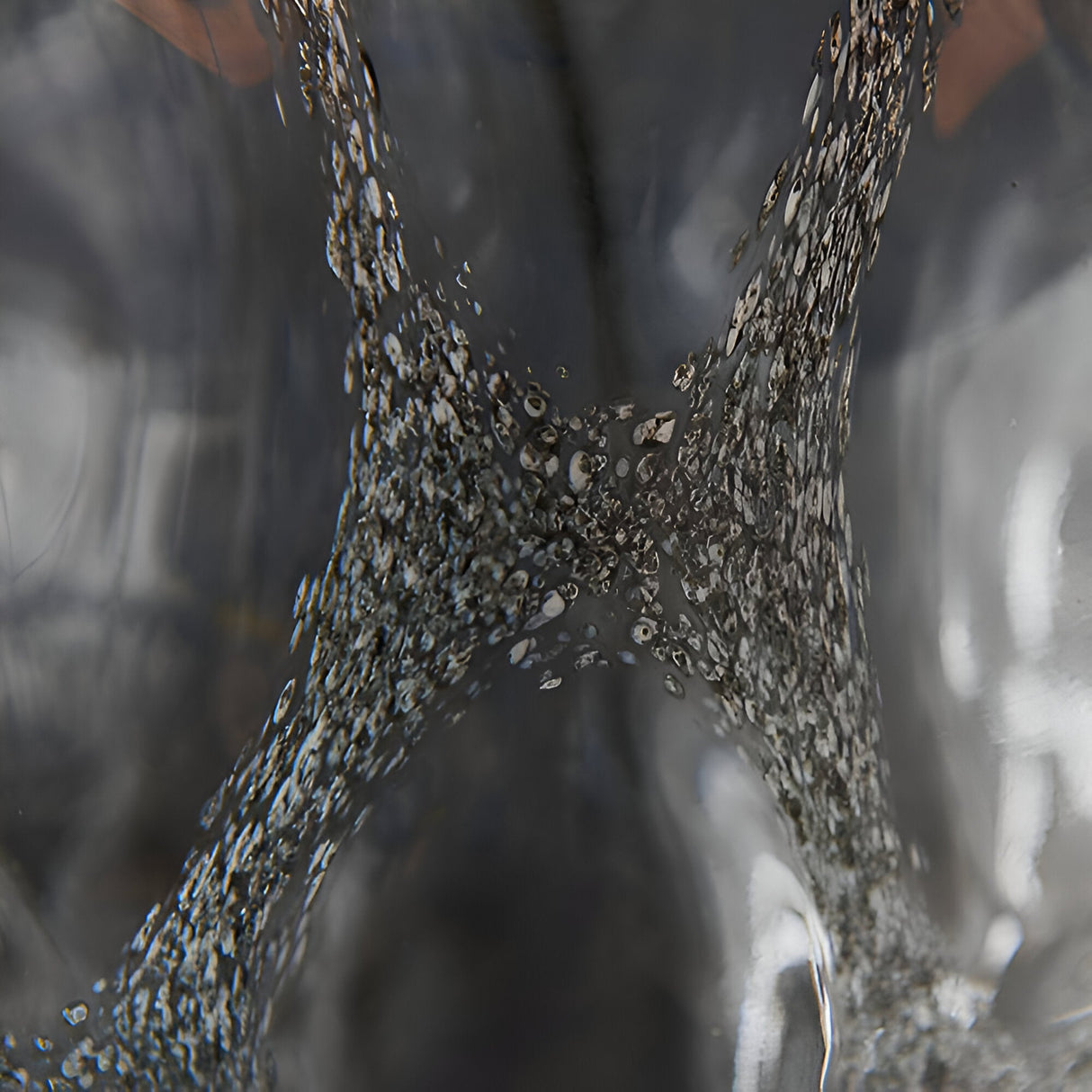 Close-up of the Endon Brenstead table lamp base showing textured charcoal-tinted artisan glass with a bubbled, hand-made finish.