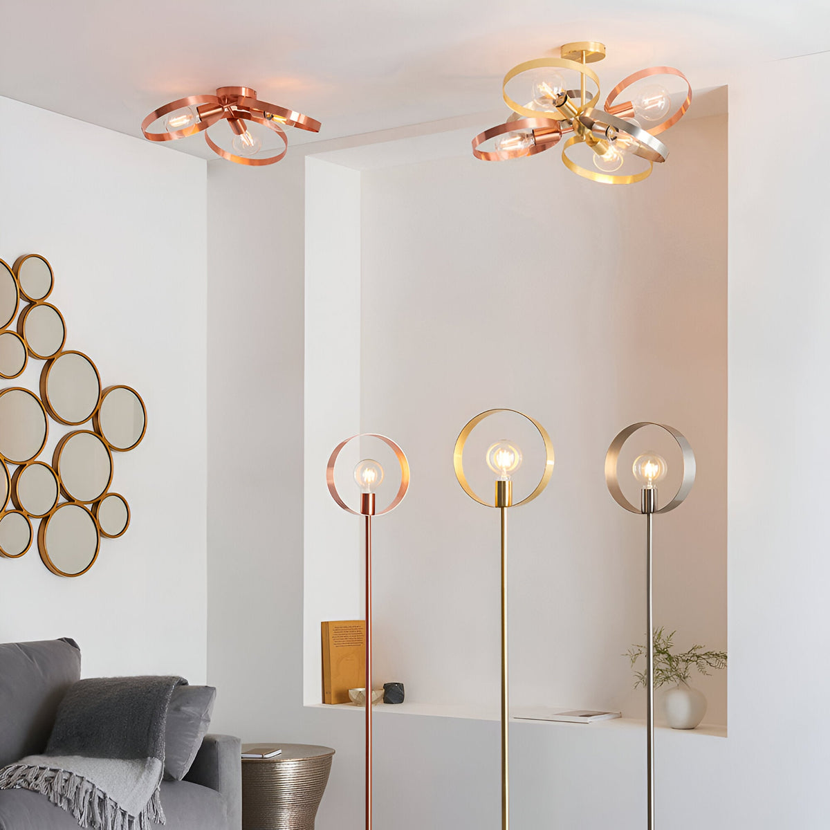 Endon Brenmere six-light pendants in brushed copper and mixed brass, copper and nickel finishes, shown with matching hooped floor lamps in a modern living room.