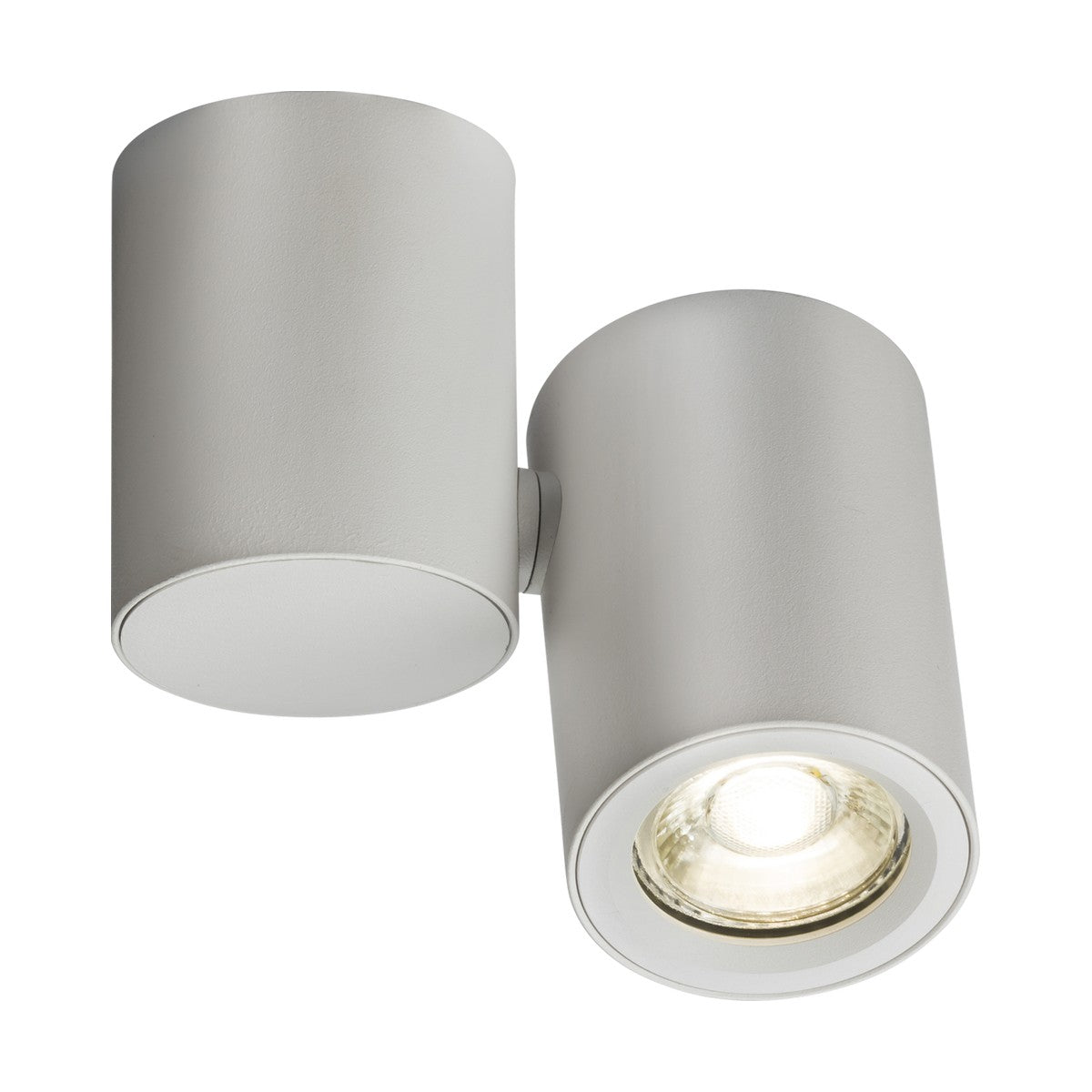 The Dee Single Round Spotlight - White is a contemporary cylindrical ceiling light fixture in a matte white finish. It offers dimmable options and comprises two sections: one enclosed and the other open, showcasing a GU10 light source that emits a bright spotlight.