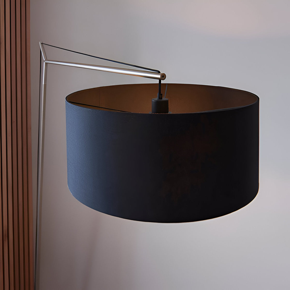 Carlfield Floor Lamp in matt nickel with a cantilevered arm and large black cotton drum shade, set against a plain light background.