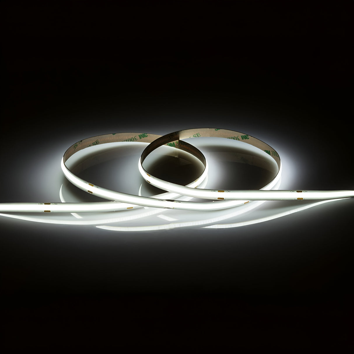 The 24V 11W COB LED Strip Light 5m - 6000K, when arranged in a loop on a dark surface, offers an elegant and modern aesthetic with its soft, dimmable illumination.