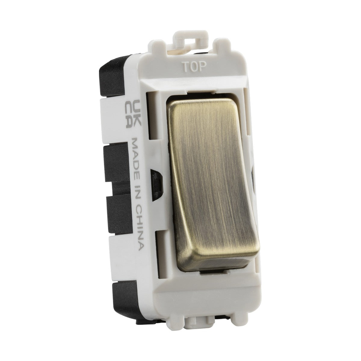 The 20AX 2 Way SP Grid Module - Antique Brass is a light switch with a rectangular design that fits seamlessly into the Knightsbridge Grid system. It features an elegant antique brass color, mounted on a white base, and includes UKCA and MADE IN CHINA markings. The word "TOP" is elegantly inscribed at the upper edge for easy orientation.