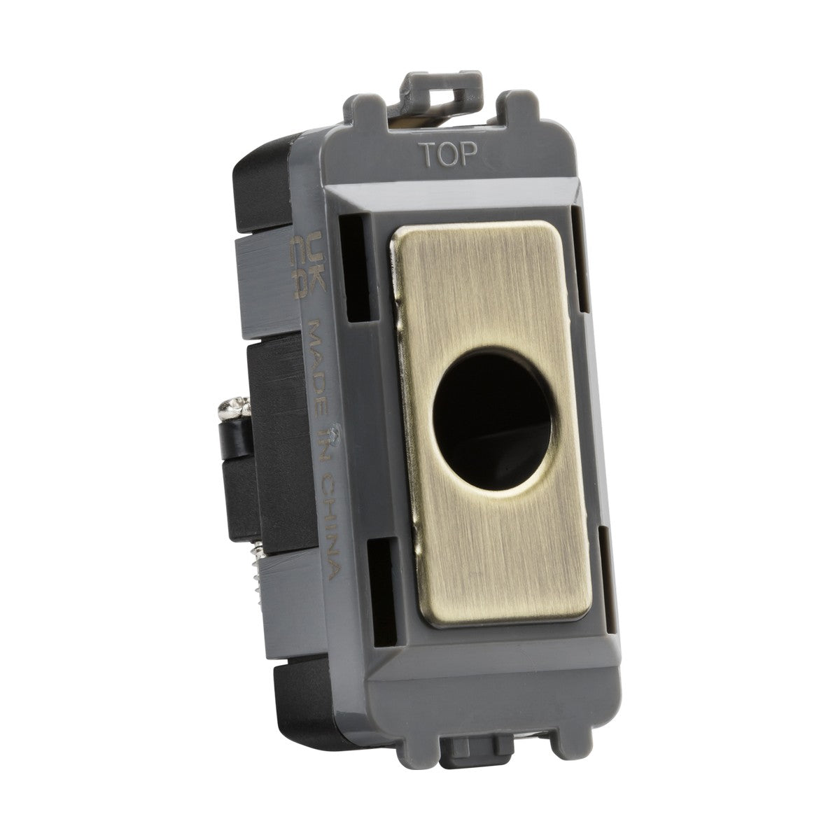 This Flex Outlet Module (Up To 10mm) in antique brass boasts a stylish rectangular design with a central circular button. The black and gray casing is marked with "TOP" on the upper edge, and notes "Made in China" on the side. Ideal for incorporating into a Knightsbridge Grid module.