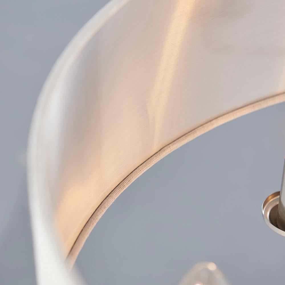 Close-up of the Brenley 6 Light Pendant in white fabric with chrome fittings, showing the curved shade edge and metallic inner lining.