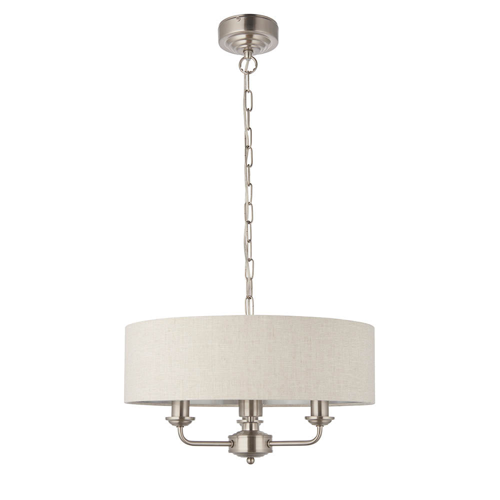 Brenley 3-light pendant with round white fabric drum shade, chrome arms and three candle-style holders, on a chain suspension against a plain white background.