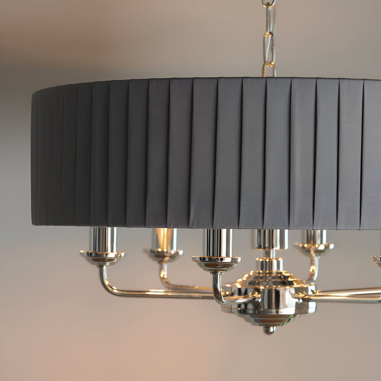 Brenley V1 6 Light Pendant in nickel and chrome, close-up of pleated grey fabric drum shade above chrome candle-style arms and chain suspension.