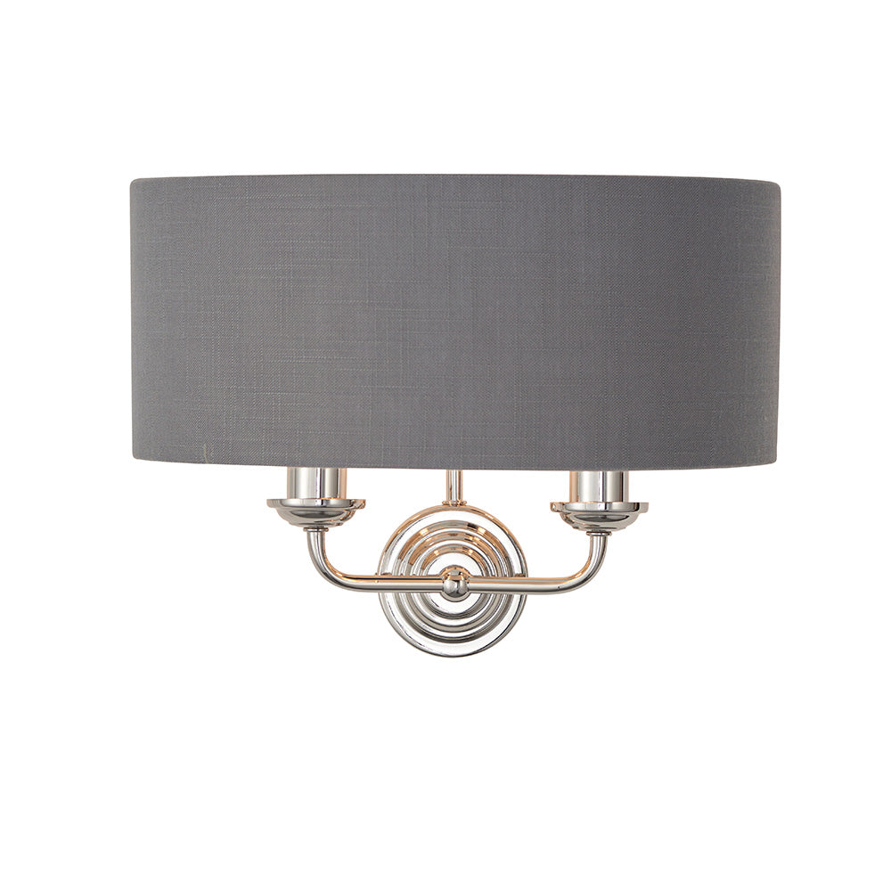 Brenley 2 Light Wall Light in nickel with a grey fabric drum shade and twin curved arms, shown on a plain white background.