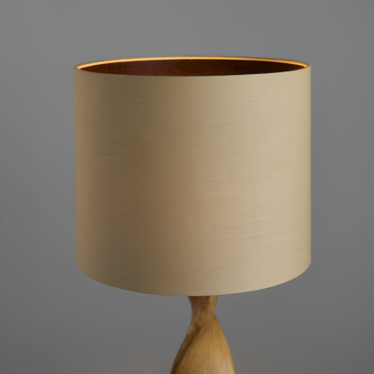 Alcott Table Lamp in Natural with cylindrical linen shade and spiral-turned oak-effect wood base, shown against a plain grey background.