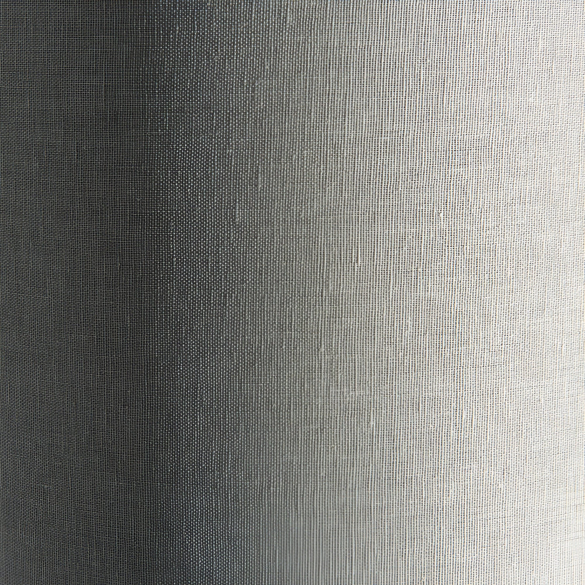 Close-up of the Endon Bramdon floor lamp's natural mixed-linen cylinder shade, showing the woven fabric texture in soft light and shadow.