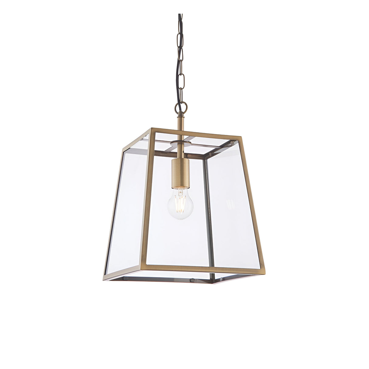 Endon Brenton lantern pendant in brass with tapered metal frame, clear glass panels and single E27 filament bulb, suspended from chain on white.