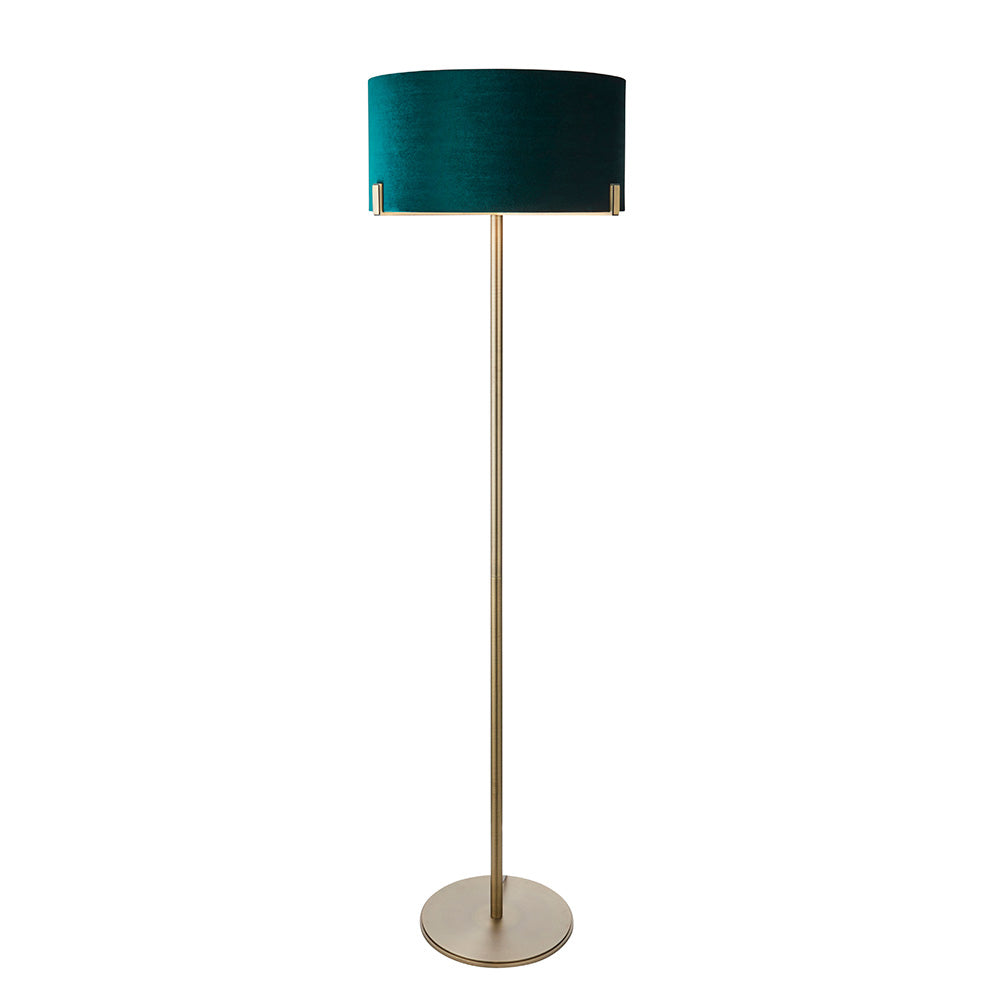 Endon Brendon floor lamp with a slim antique brass stem, round base, and green velvet cylinder shade held directly on the metalwork, on a white background.